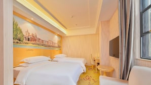 A hotel room with two beds, a television, a small table, and a window with curtains. - Vienna 3 Best Hotel Xili Nan Ke Da (Shenzhen)