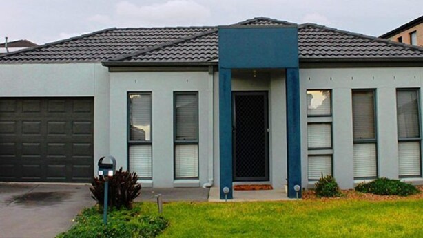 A modern two-story house with a garage, a front door with a blue accent, and a small front yard. - City Cottage (GOWANBRAE)