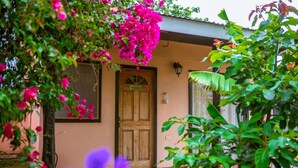 A wooden door labeled "MAHANA 2" with a tiled entrance and a small overhang. - Cabañas Vaiora (Hanga Roa)