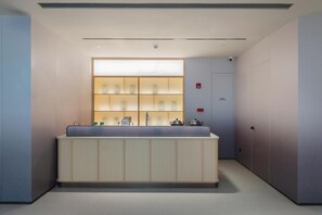 A modern kitchen with a central island, a built-in refrigerator, and a wall-mounted oven. - JI Hotel Guangzhou Tianhe East Railway Station (Guangzhou)