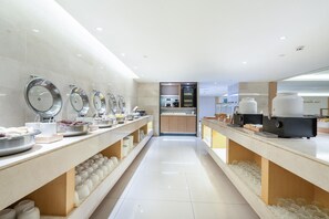A modern buffet setup with multiple food stations, a coffee machine, and a self-service beverage dispenser. - JI Hotel Guangzhou Tianhe East Railway Station (Guangzhou)