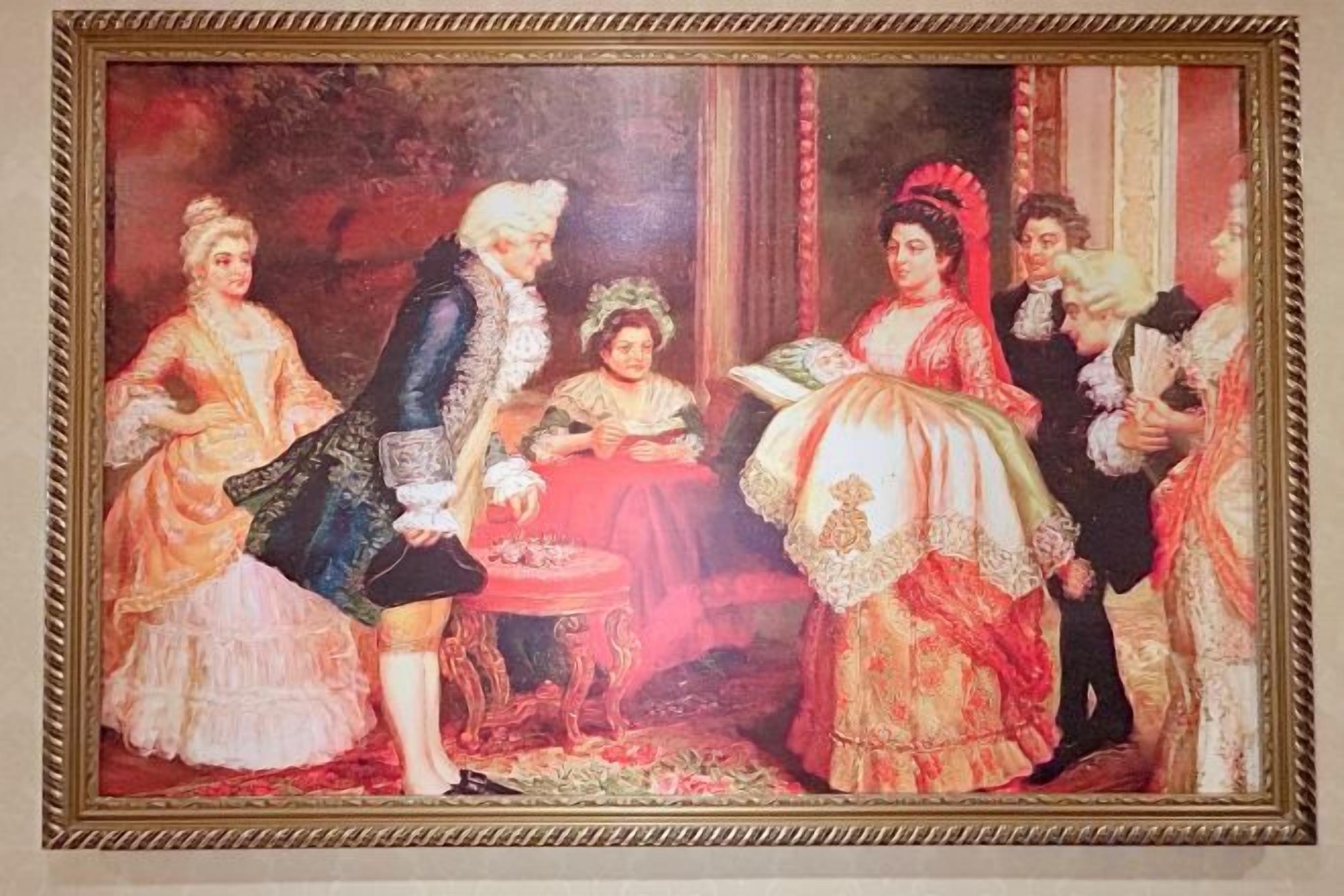 A framed painting with a group of people in historical attire.