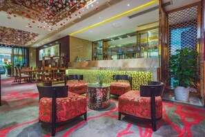 A hotel lobby with a bar area, seating with patterned upholstery, and a decorative ceiling. - Chongqing Plaza Hotel (Chongqing)
