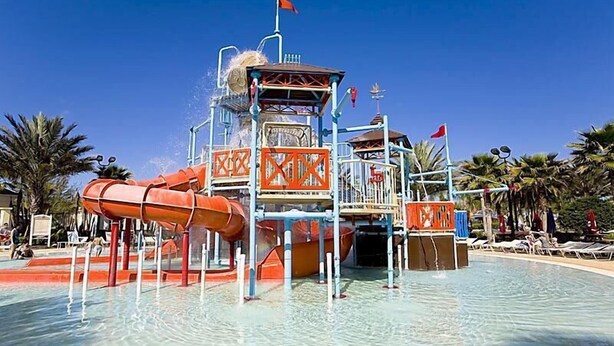 A water park with a central water slide, multiple levels, and a clear blue sky. - Reunion Resort - 3 BR Condo, Ground Floor, Patio - JHH 45890 (Kissimmee)