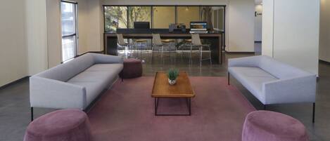 A modern interior with a sofa set, a wooden coffee table, and a rug.