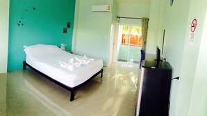 A room with a bed, a window, and a door. - Won DD Place (Roi Et)