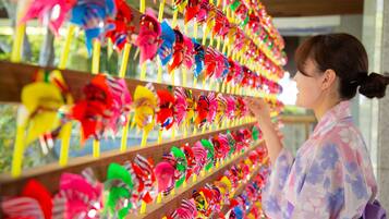 A person browsing colorful pinwheels on shelves.