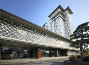 A modern building with a glass facade and a covered entrance area. - Yumoto Takubokutei (Hakodate)