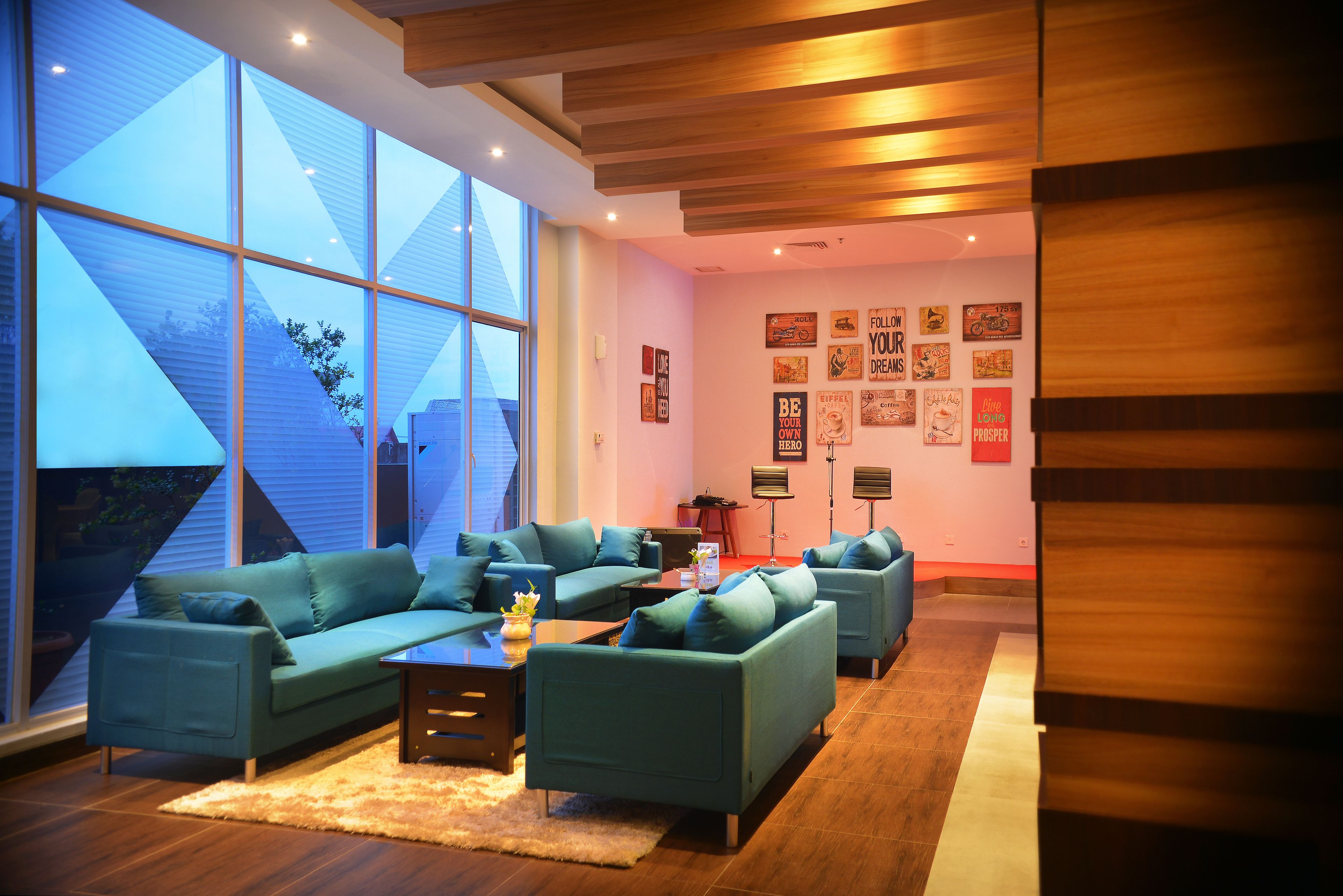 A modern living room with large windows, a sectional sofa, and a coffee table.
