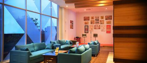 A modern living room with large windows, a sectional sofa, and a coffee table.