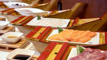Un bar de sushi con diferentes tipos de sushi expuestos en bandejas de madera.