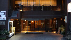 A two-story building with a traditional Japanese entrance, a visible staircase, and a signboard on the left. - Konpira-spa Yumoto Yachiyo (Kotohira)