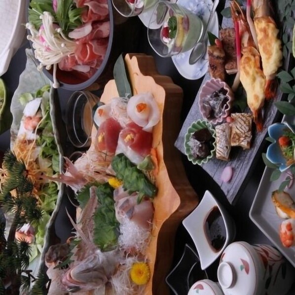 A variety of sushi and sashimi dishes on a wooden table.