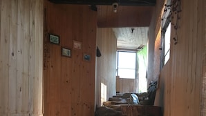 A wooden interior with stone steps leading to a higher level. - Ryokan Sansui (Takayama)