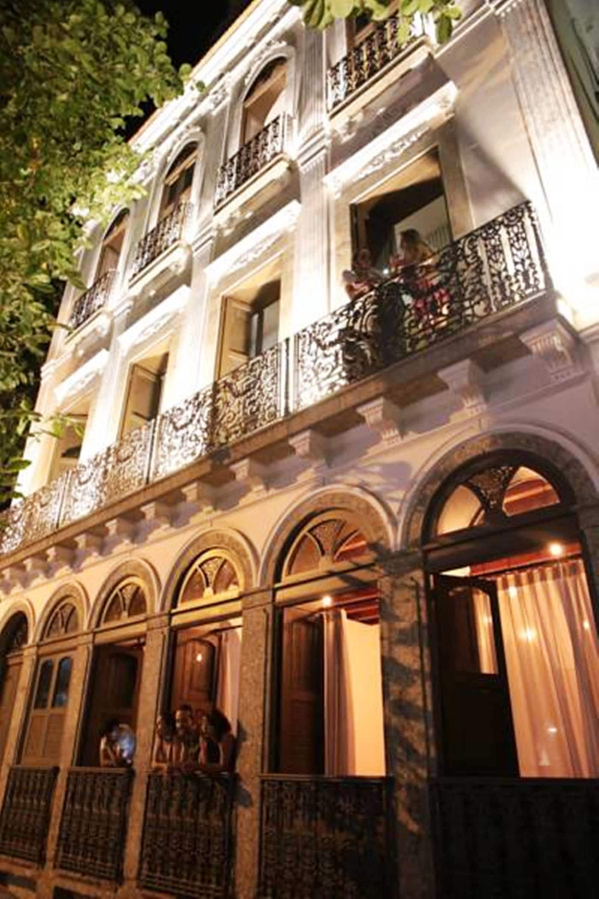 A multi-story building with ornate balconies and arched windows.