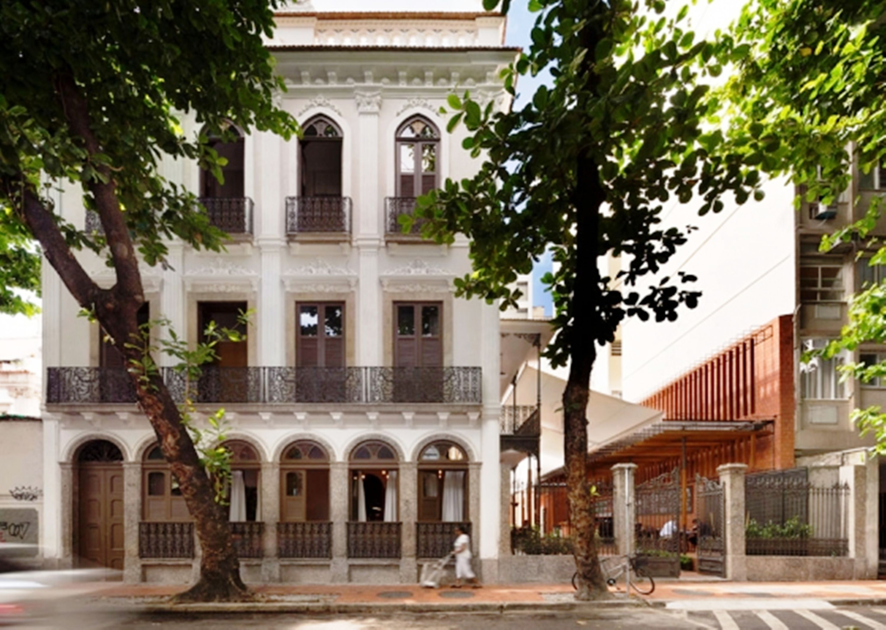 A multi-story building with a classical architectural style, featuring arched windows and balconies.