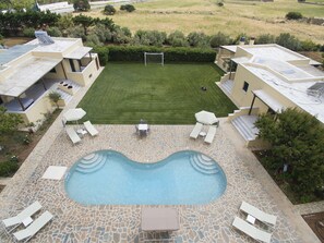 A swimming pool with lounge chairs and a patio area.