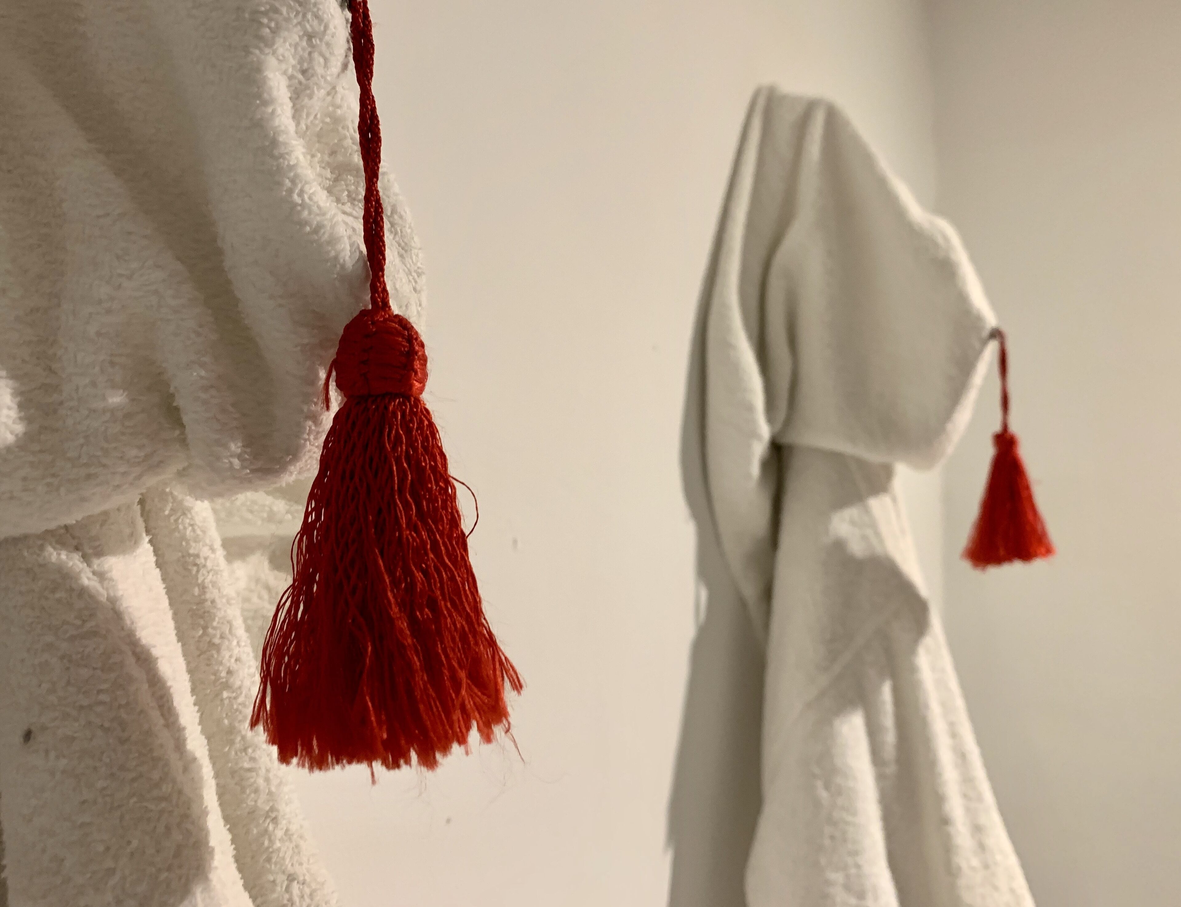 A white towel hanging on a wall.
