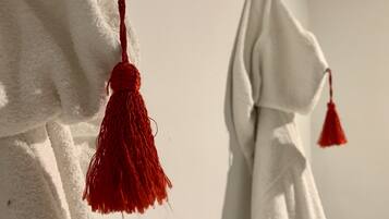 A white towel hanging on a wall.