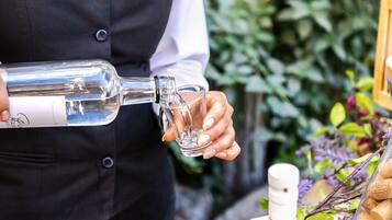 Una persona vertiendo un líquido transparente de una botella a un vaso.