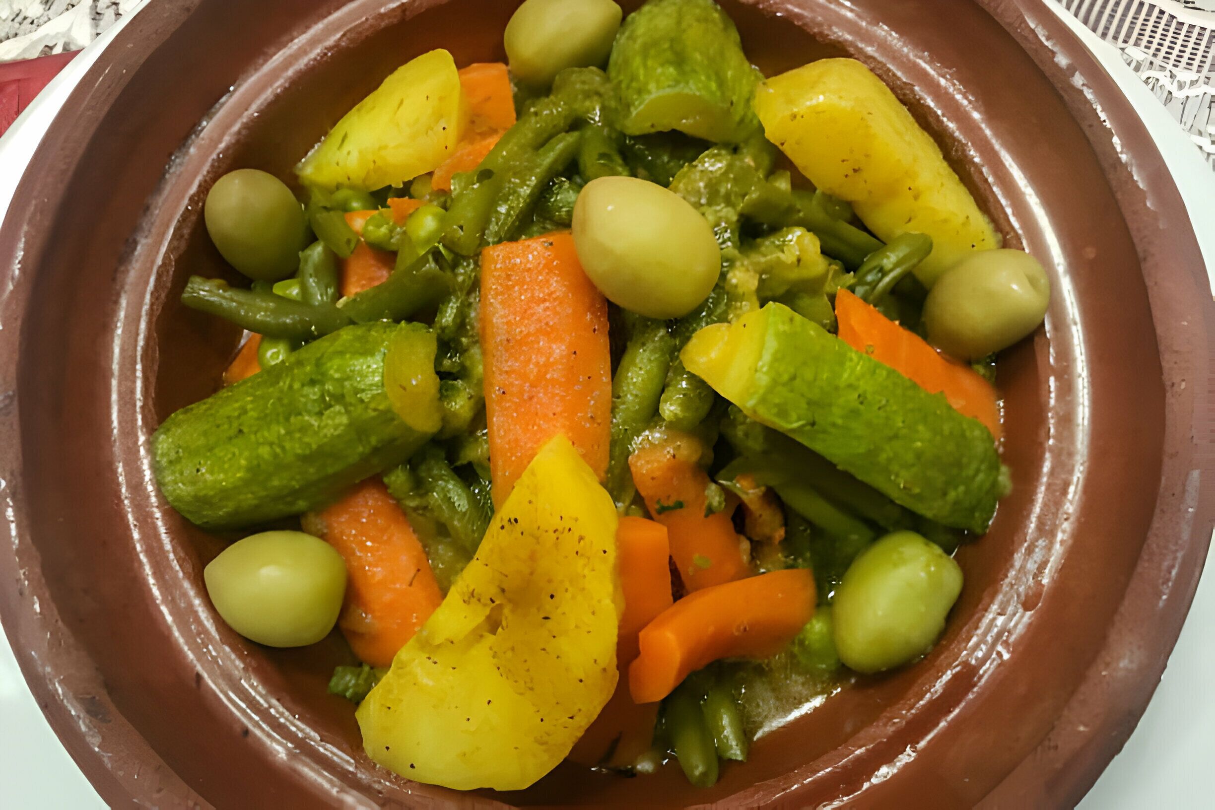 A dish of vegetables in a clay pot.