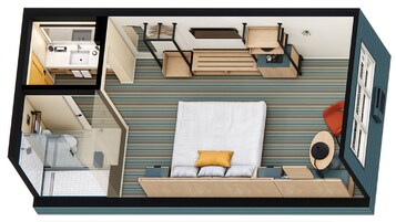 A hotel room with a bed, a desk, a chair, a small table, and a window.