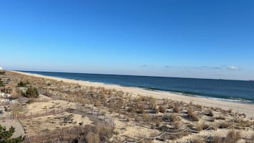 On the beach, white sand, sun loungers, beach towels