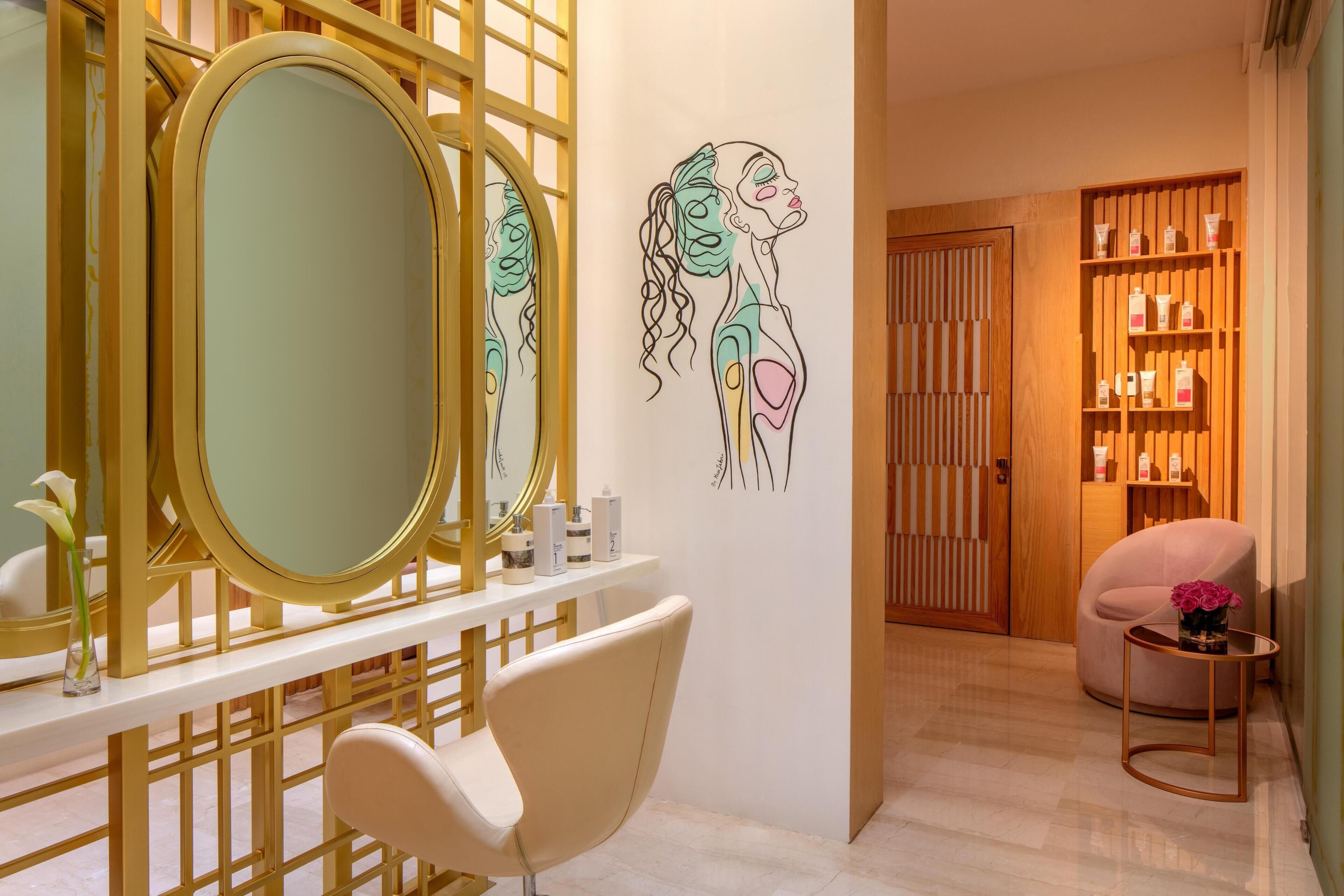 A modern bathroom with a large mirror, a white chair, and a wall with a minimalist design.