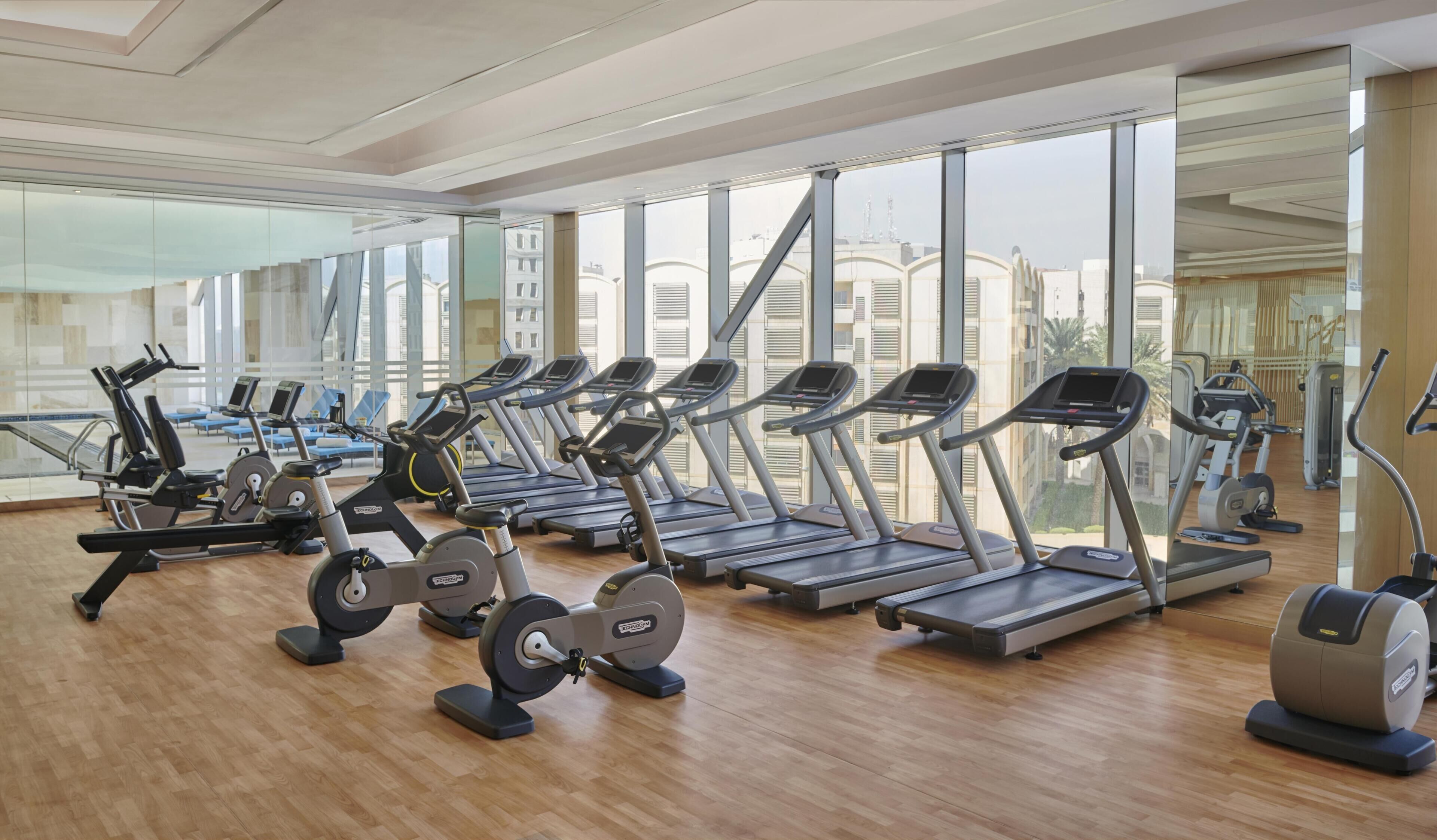 A gym with treadmills, ellipticals, and weight machines.