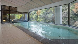 An indoor swimming pool with clear views of trees and a covered roof. - Select Grand Kagayamanaka (Kaga)