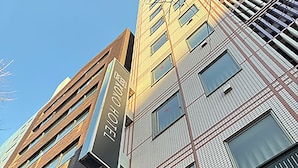 Een meerhoog hotelgebouw met een opvallend bord waarop 'HOTEL' staat.