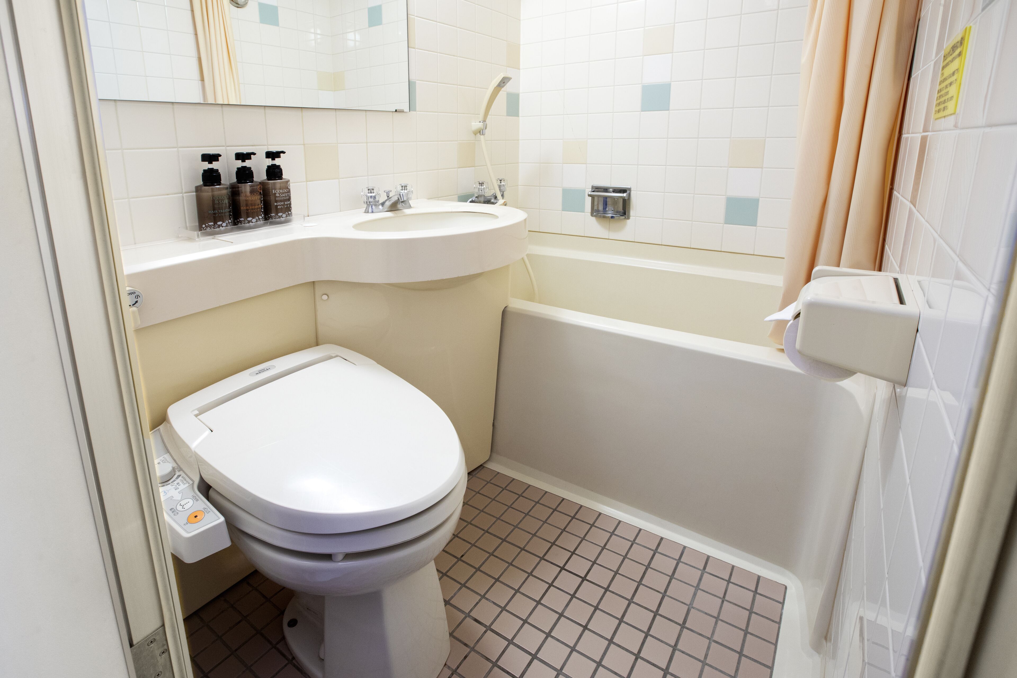 A bathroom with a toilet, sink, and bathtub.