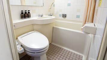 A bathroom with a toilet, sink, and bathtub.