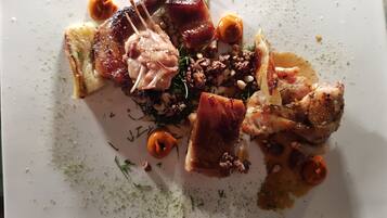 A plate of food with various meats and vegetables.