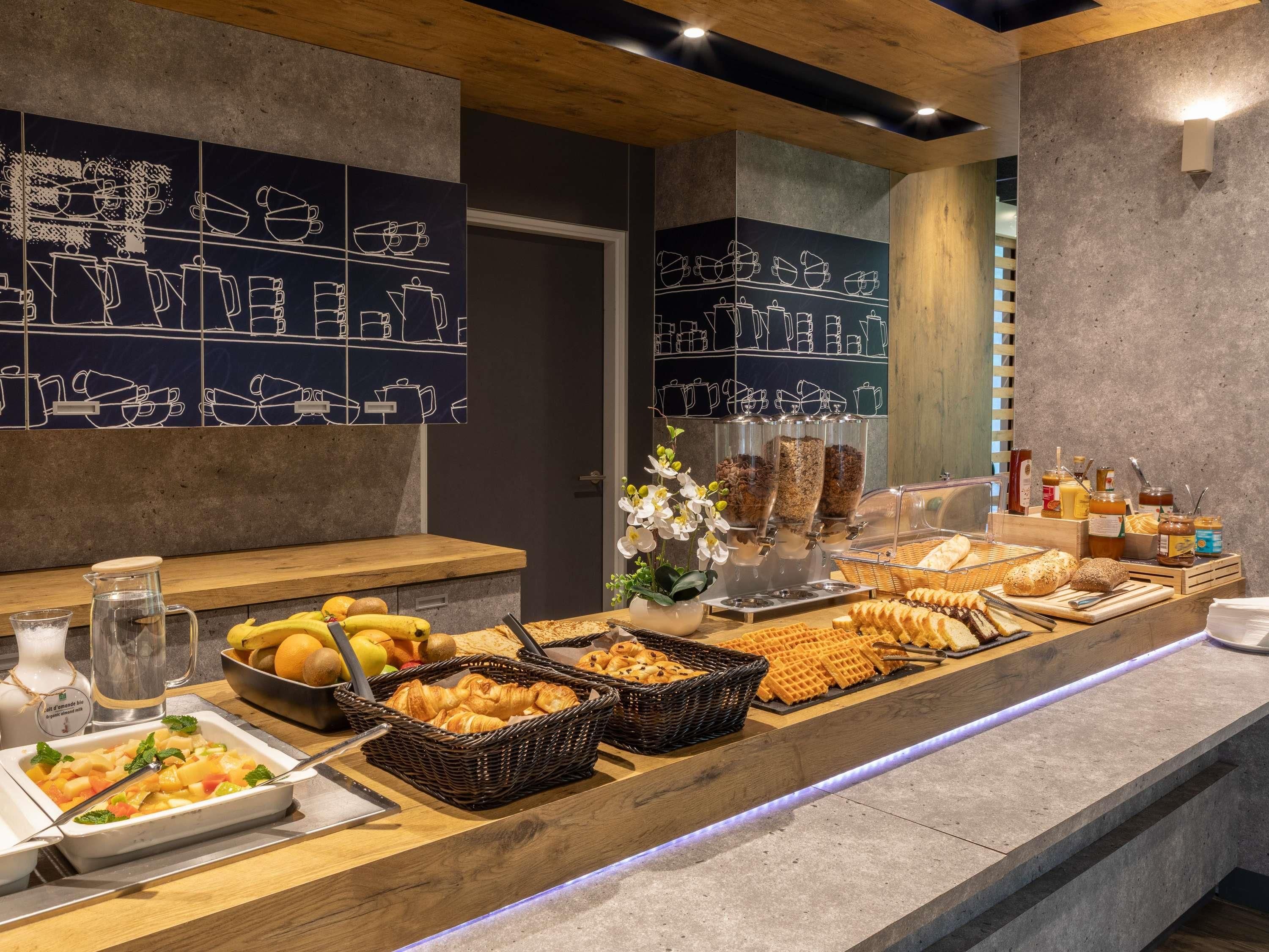 A breakfast buffet with various food items and a coffee station.