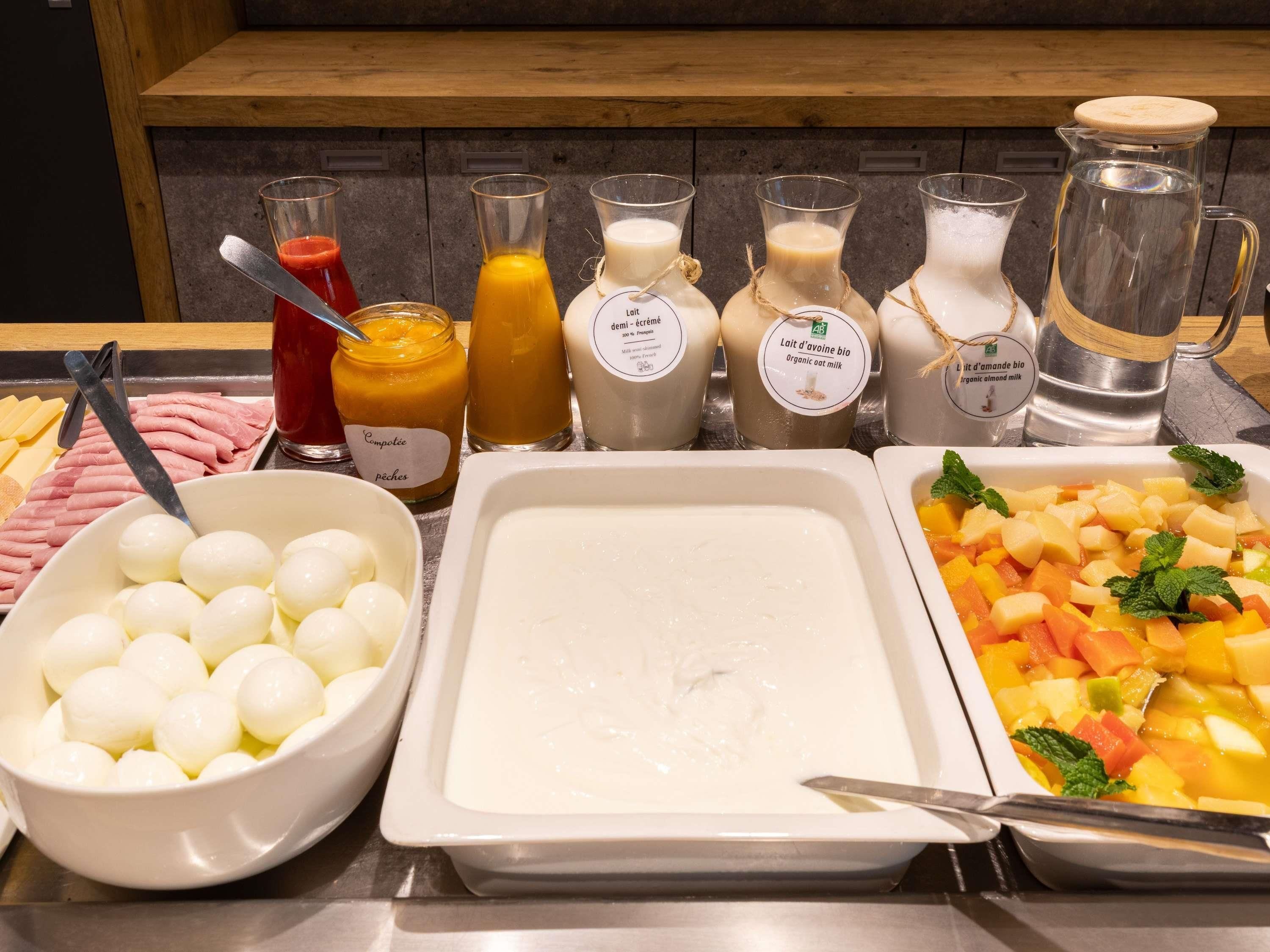 A buffet with various food items and beverages.
