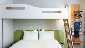 A bunk bed with a green headboard and white bedding, a ladder, and a shelf with clothes and a bag. - ibis budget Saint Quentin en Yvelines Velodrome (Montigny-le-Bretonneux)