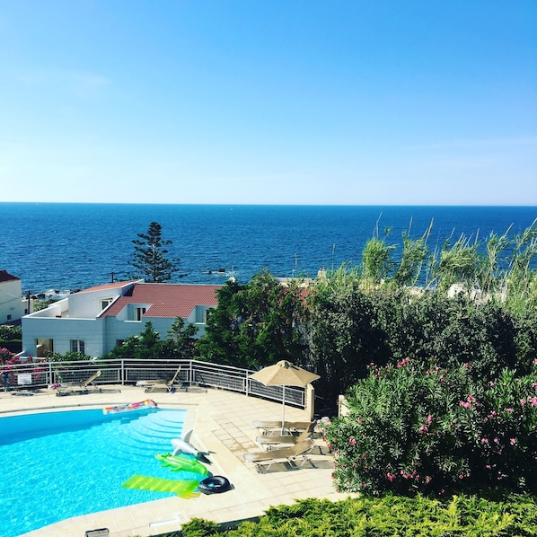 Seasonal outdoor pool, open 9:00 AM to 7:00 PM, pool umbrellas