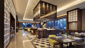 A modern hotel lobby with a checkered floor, a central bar area, and seating arrangements. - Novotel Nanchang Sunac (Nanchang)
