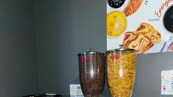A breakfast buffet with various food items and a coffee machine.
