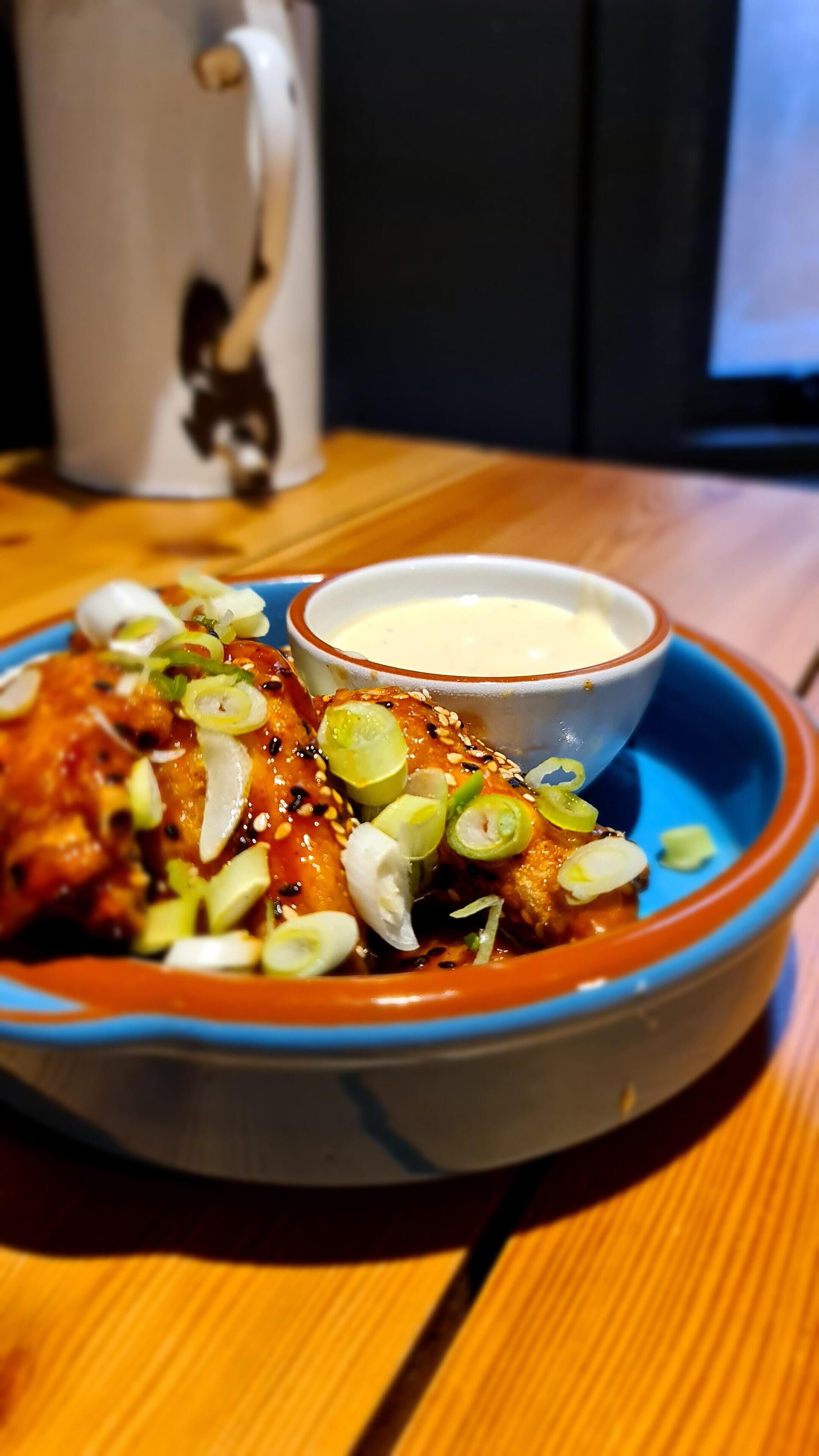 A plate of food with a side of dipping sauce.