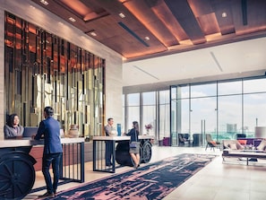 A modern hotel lobby with a reception desk, large windows, and a city view. - Mercure Bangkok Makkasan (Bangkok)