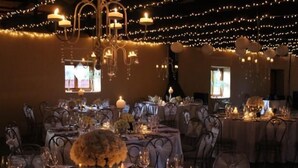 A banquet hall with tables set for a formal event, decorated with candles and floral centerpieces. - Oranje Gasteplaas Maloti Route (Fouriesburg)