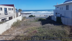 A coastal residential area with houses overlooking the beach. - Melkbosch Guesthouse (Cape Town)