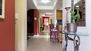 A hallway with a dining area, a kitchen, and a living space. - The Inn at 6 (Kingston)