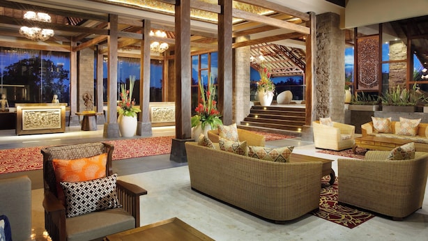 A spacious lobby with high ceilings, wooden beams, and a grand staircase. There are multiple seating areas with wicker furniture and decorative vases. - Sthala, A Tribute Portfolio Hotel, Ubud Bali (Ubud)