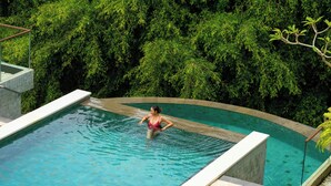 A woman in a pool surrounded by lush greenery. - Sthala, A Tribute Portfolio Hotel, Ubud Bali (Ubud)