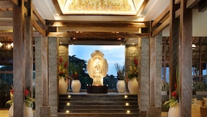 A grand entrance with a central statue, stone pillars, and a patterned carpet. - Sthala, A Tribute Portfolio Hotel, Ubud Bali (Ubud)