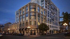 A multi-story hotel with a prominent 'PENDR' sign, large windows, and a corner entrance. - Pendry San Diego (San Diego)