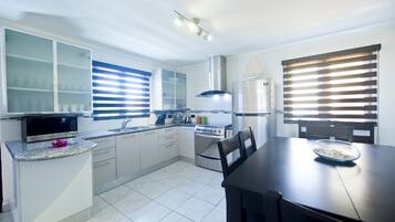 Family Villa, 4 Bedrooms, Patio | Private kitchen | Fridge, microwave, coffee/tea maker, toaster